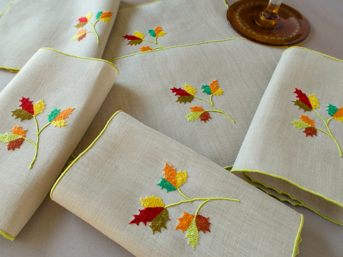 Marghab Maple Leaf cocktail napkins, hand embroidered in warm autumn tones on fine linen.