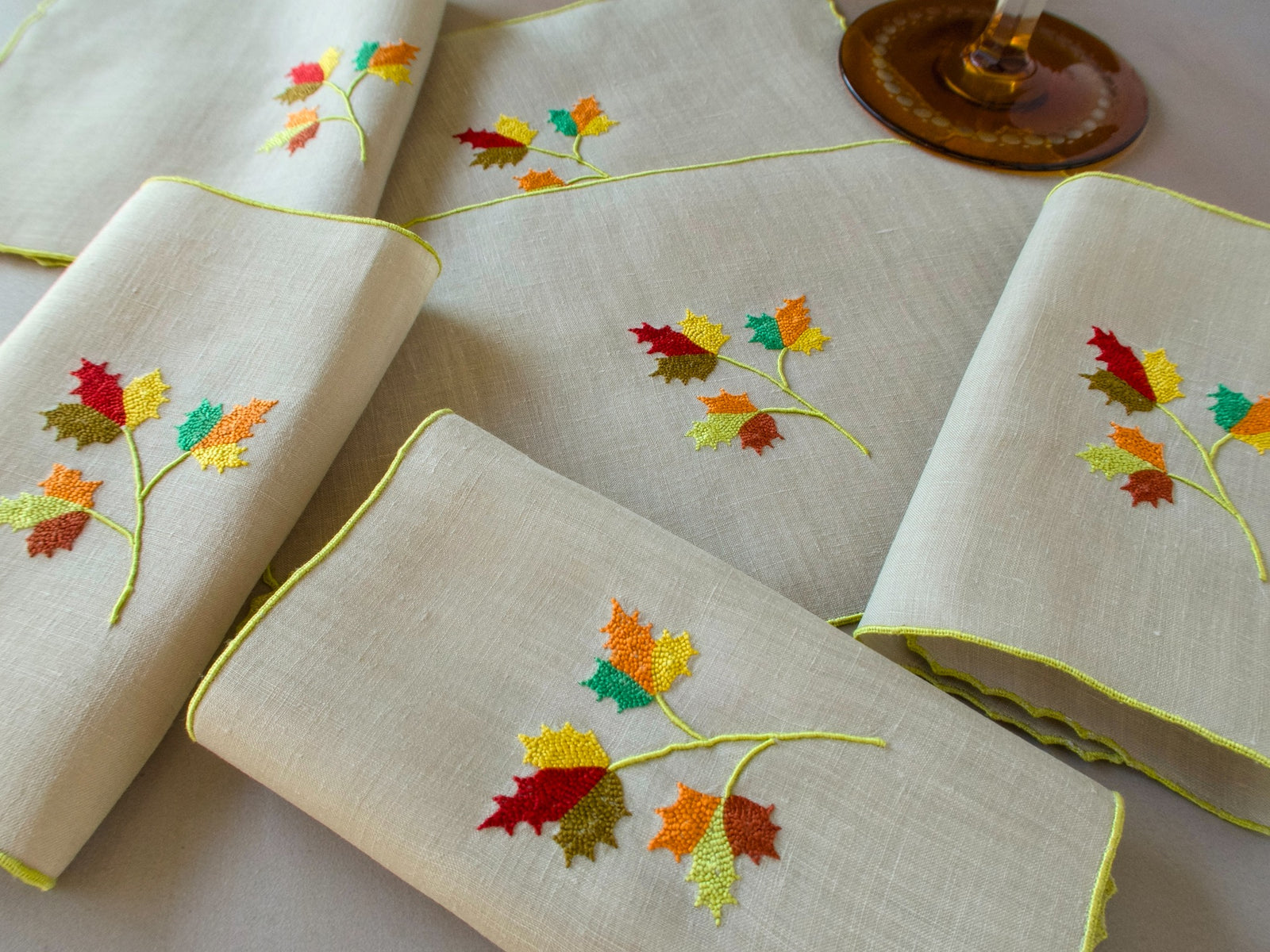 Marghab Maple Leaf cocktail napkins, hand embroidered in warm autumn tones on fine linen.
