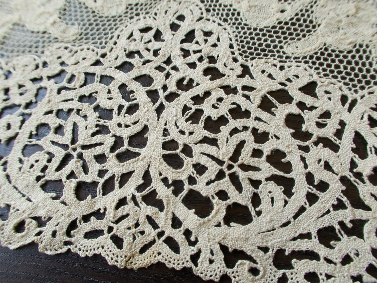 Close view of the bobbin lace border on an antique placemat