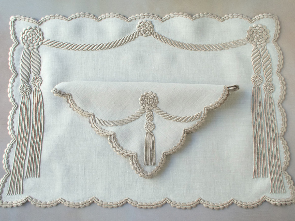 Vintage Marghab “Cord &amp; Tassel” placemat and napkin set, hand embroidered in Madeira on fine linen with intricate raised cord and tassel motifs in dimensional relief.