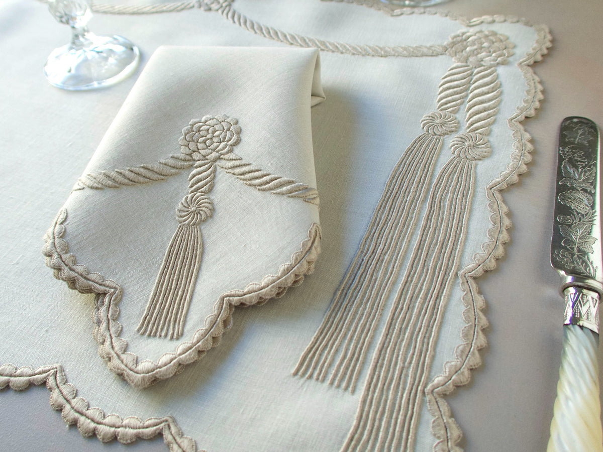 Vintage Marghab “Cord &amp; Tassel” placemat and napkin set, hand embroidered in Madeira on fine linen with intricate raised cord and tassel motifs in dimensional relief.