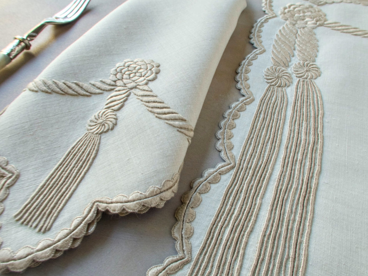 Vintage Marghab “Cord &amp; Tassel” placemat and napkin set, hand embroidered in Madeira on fine linen with intricate raised cord and tassel motifs in dimensional relief.