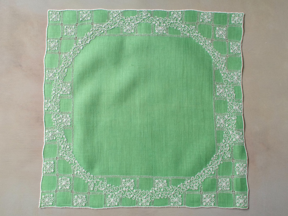 Vintage Marghab “Wreath Over Square” handkerchief, hand embroidered in white on green linen with intricate raised stitching and fine caseado bastido edging.