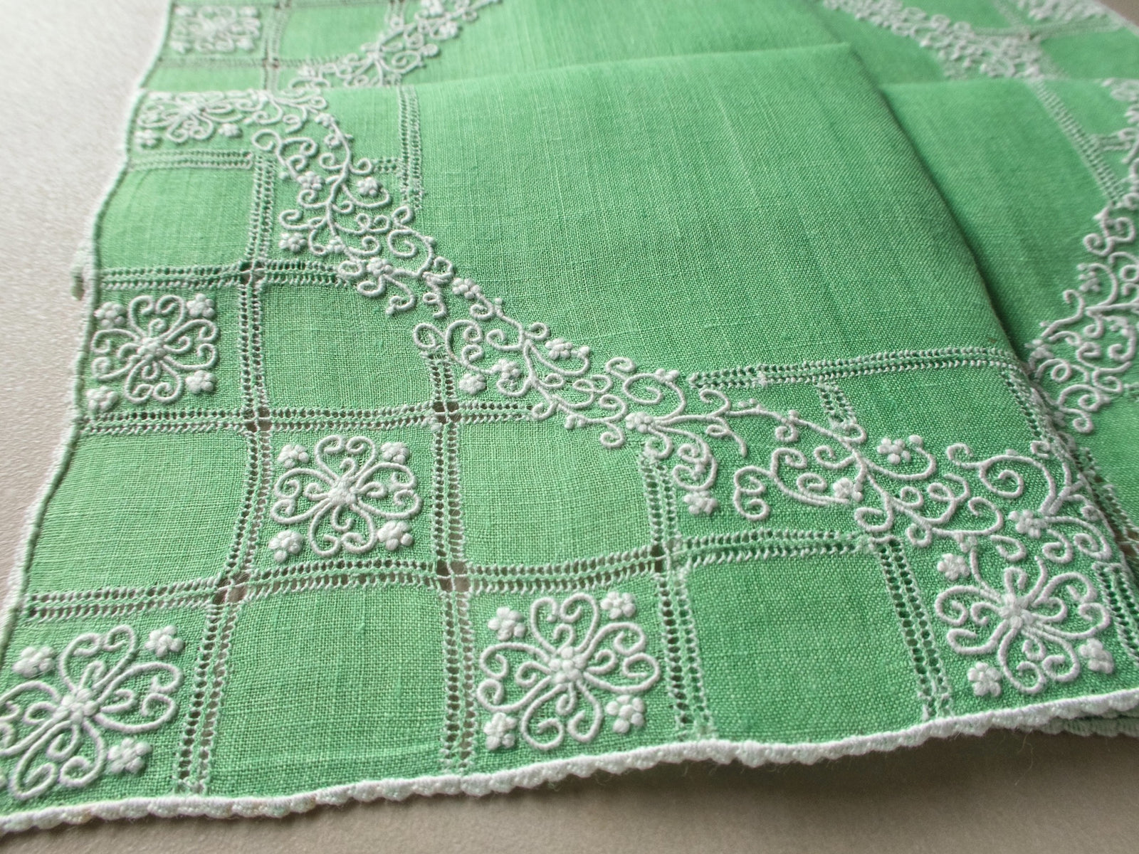 Vintage Marghab “Wreath Over Square” handkerchief, hand embroidered in white on green linen with intricate raised stitching and fine caseado bastido edging.