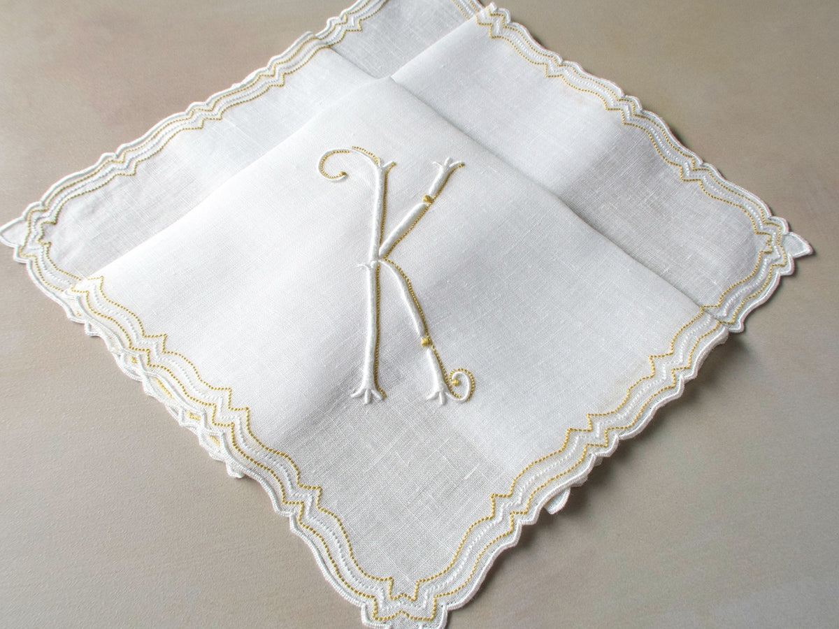 Vintage Marghab handkerchief in the “Initials” pattern, featuring a gold-embroidered “K” monogram with scalloped white border on fine linen. Hand embroidered in Madeira.
