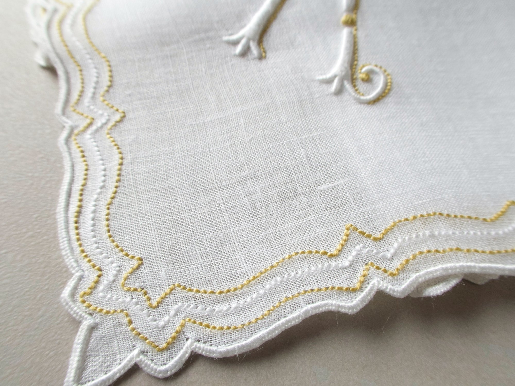 Vintage Marghab handkerchief in the “Initials” pattern, featuring a gold-embroidered “K” monogram with scalloped white border on fine linen. Hand embroidered in Madeira.