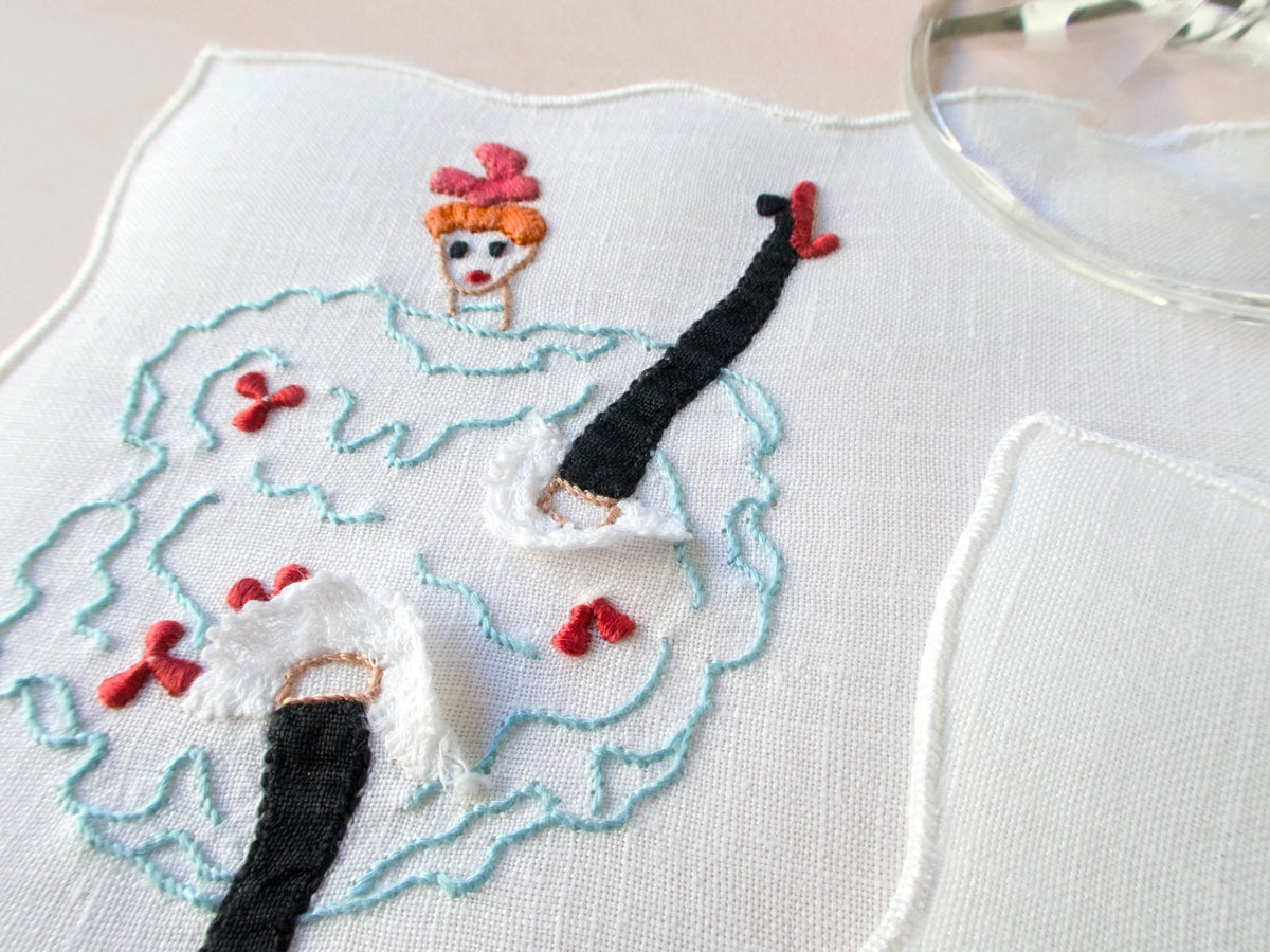Vintage Madeira cocktail napkin with embroidered can-can dancer, frilly knickers, and applied lace.