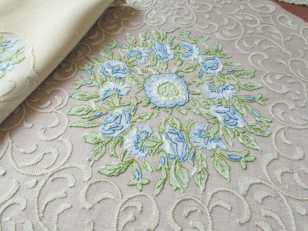 Detail of Madeira shadow work blue flower embroidery on sheer organdy placemat, caseado bastido scalloped edge