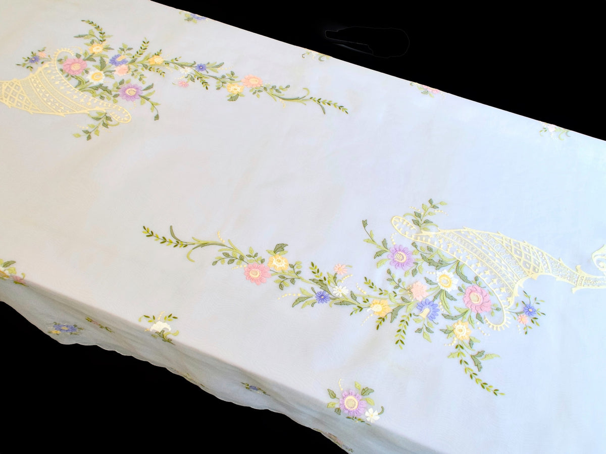 Vintage organdy tablecloth draped over table showing scattered floral embroidery