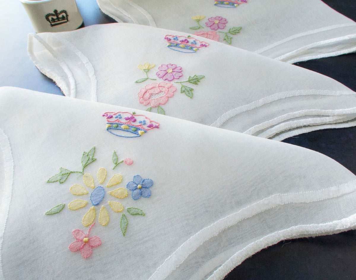Stack of vintage Italian organdy napkins with colorful hand embroidery, likely mid-century Italian work.