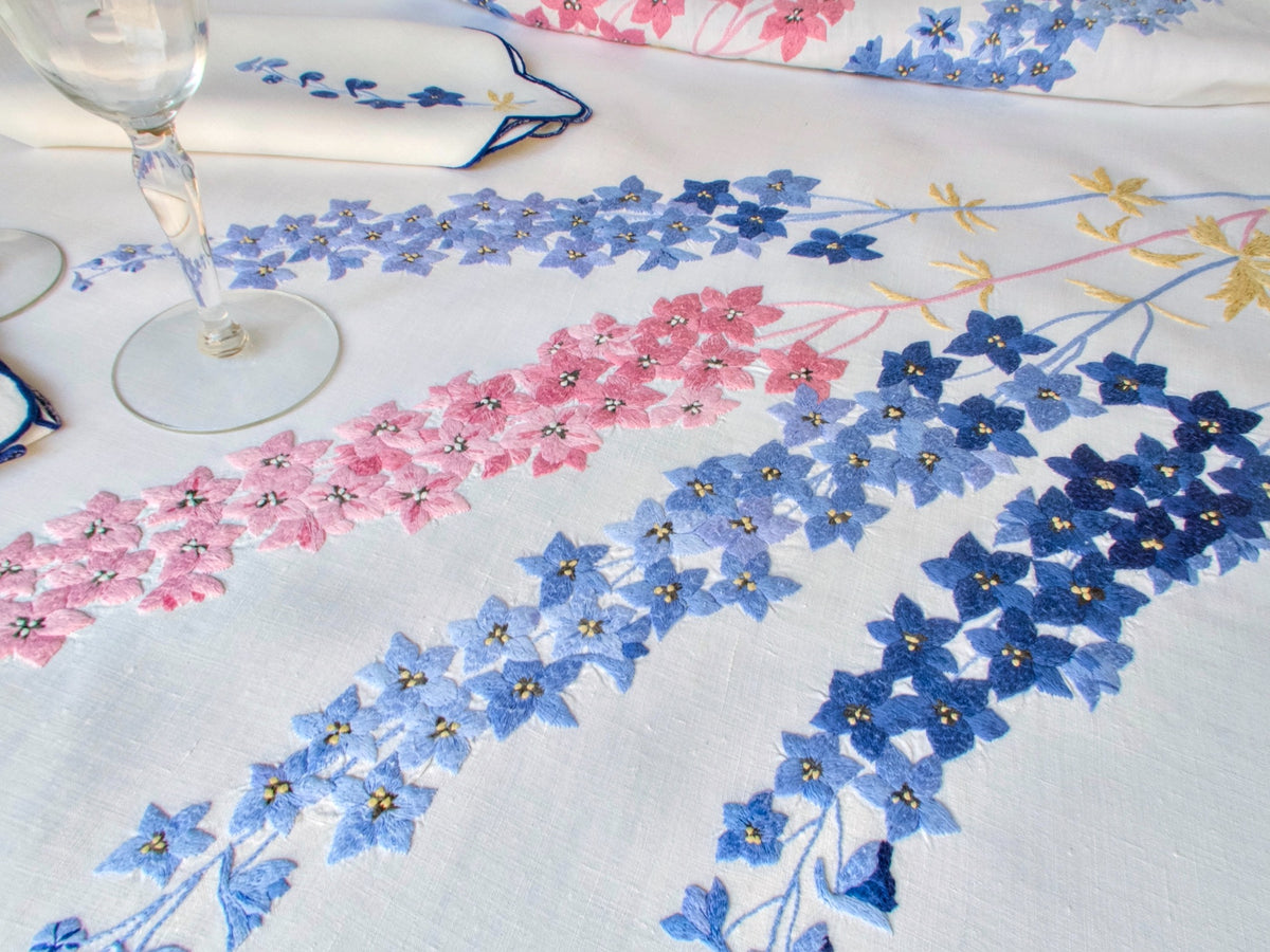 Vintage hand embroidered French linen tablecloth with delphinium garlands in blue and rose