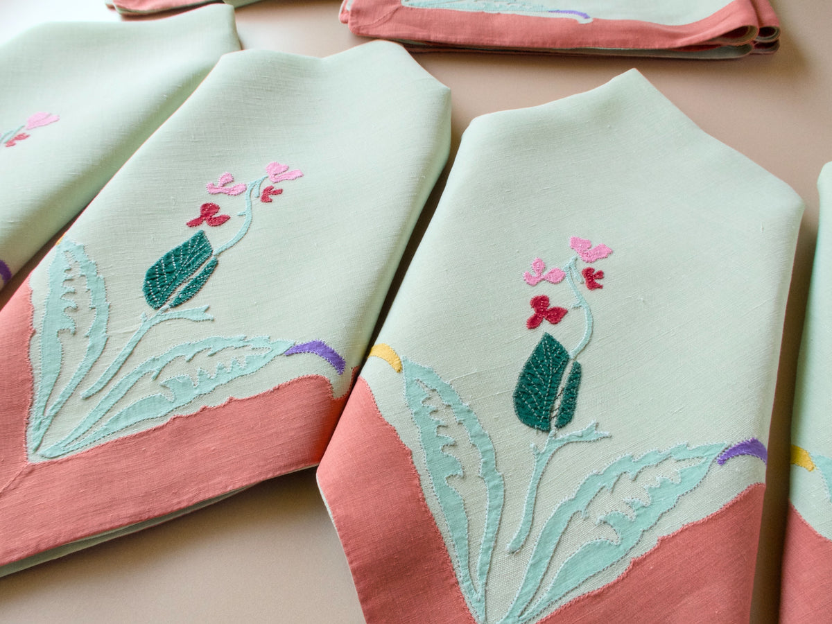 Vintage French appliqué linen dinner napkins, soft sage with warm coral borders, set of 12, folded