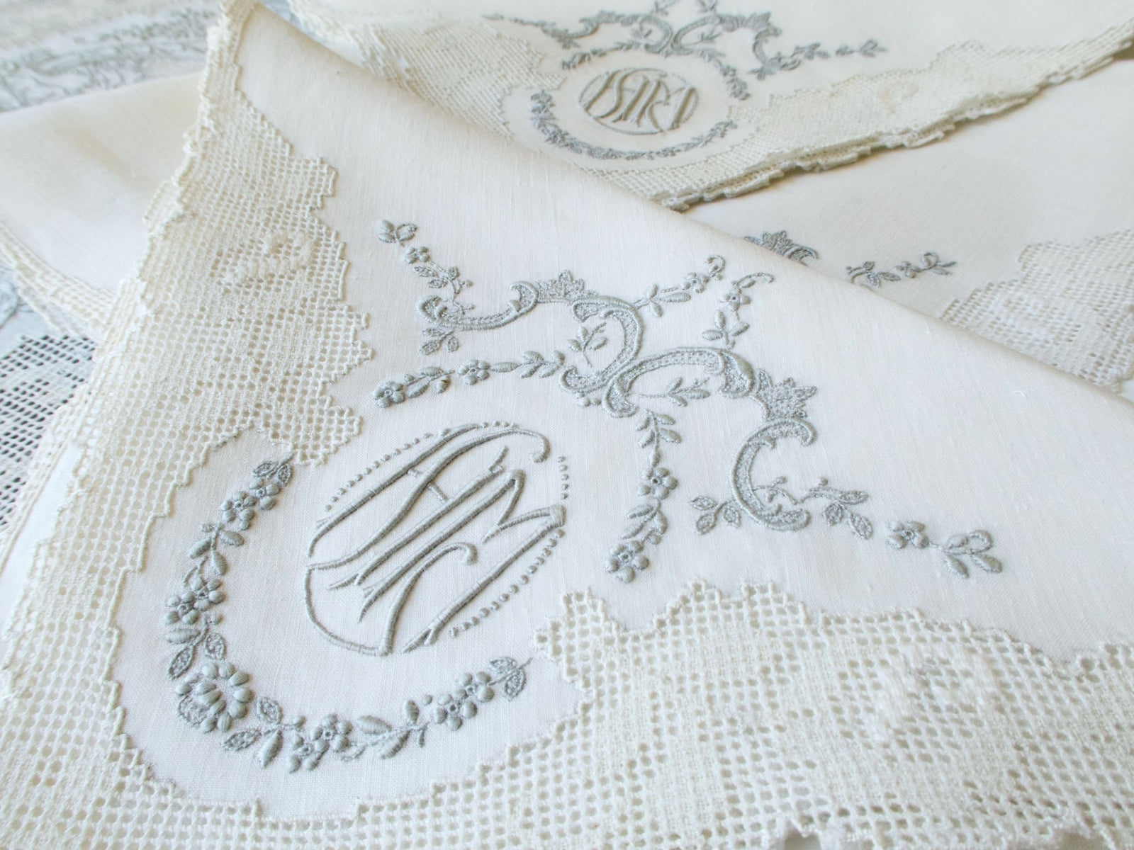 Triple monogram close-up, Appenzell linen napkin, hand embroidered, vintage Swiss needlework detail​​​​​​​​​​​​​​​​