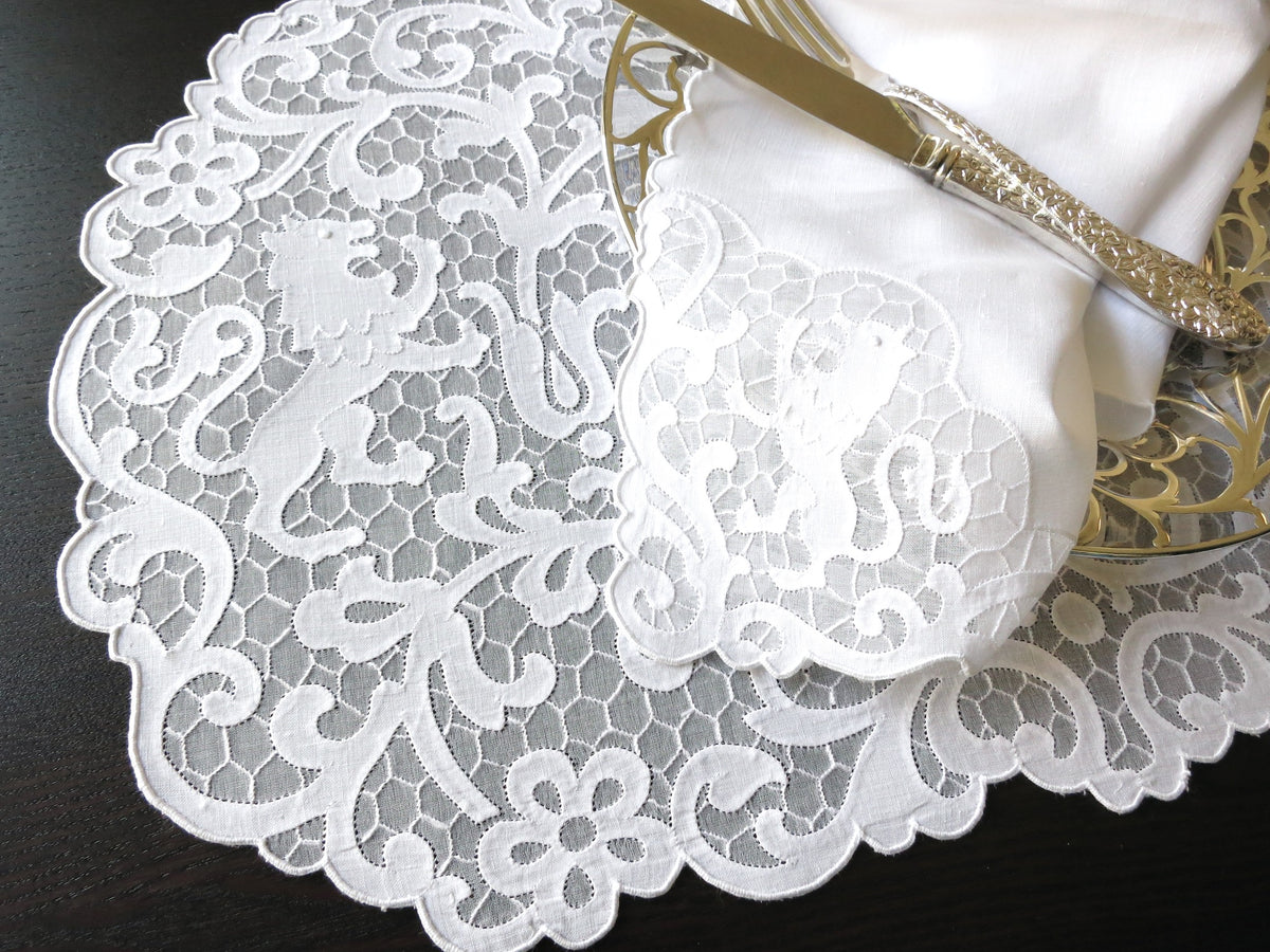 Vintage Madeira linen placemat and napkin set featuring heraldic lion embroidery on a delicate honeycomb background.