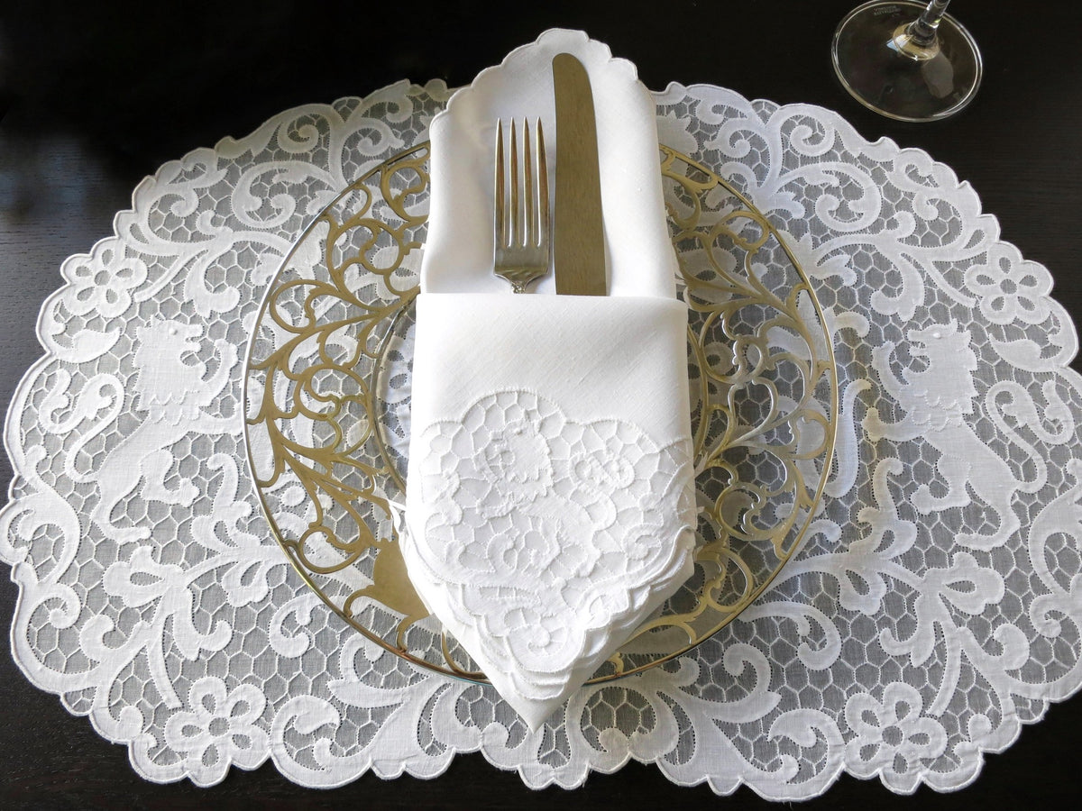 Vintage Madeira linen placemat and napkin set featuring heraldic lion embroidery on a delicate honeycomb background.