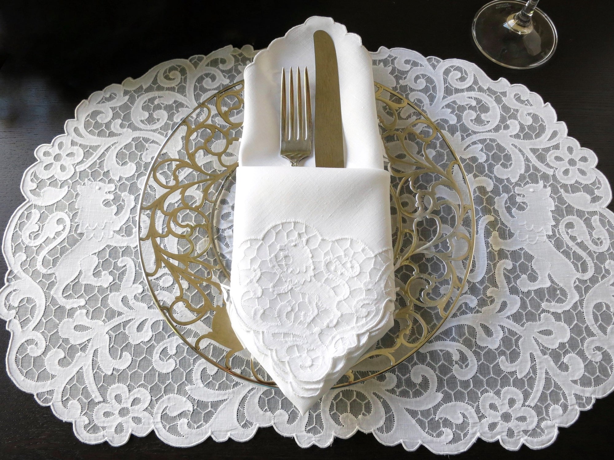 Vintage Madeira linen placemat and napkin set featuring heraldic lion embroidery on a delicate honeycomb background.