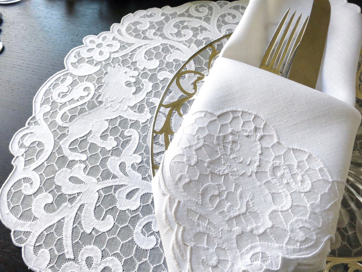 Vintage Madeira linen placemat and napkin set featuring heraldic lion embroidery on a delicate honeycomb background.