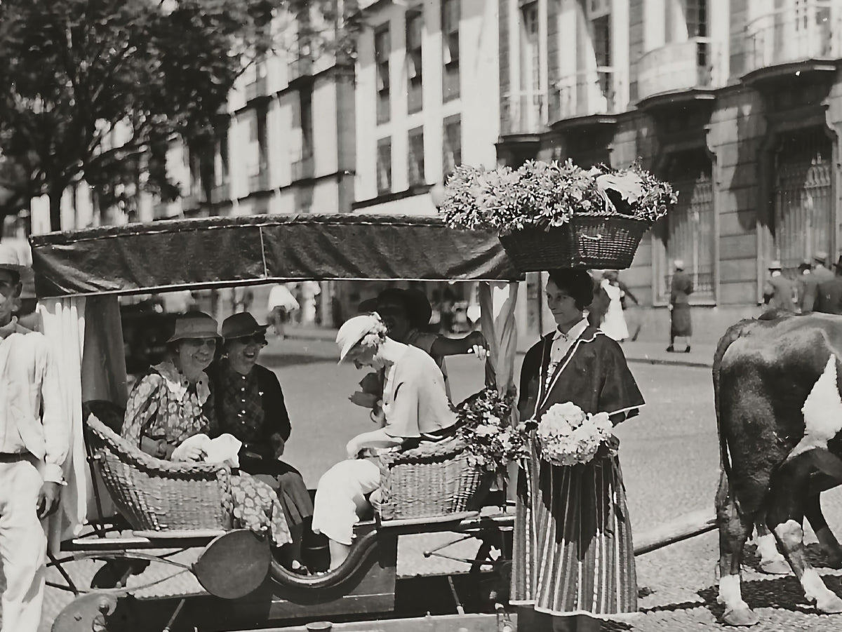 Vintage photograph of a Madeiran flower lady balancing a basket of flowers on her head, the inspiration for Marghab’s Flower Woman design​​​​​​​​​​​​​​​​