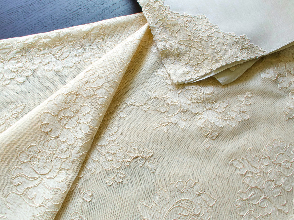 Detail of scalloped floral lace edge on vintage French tablecloth