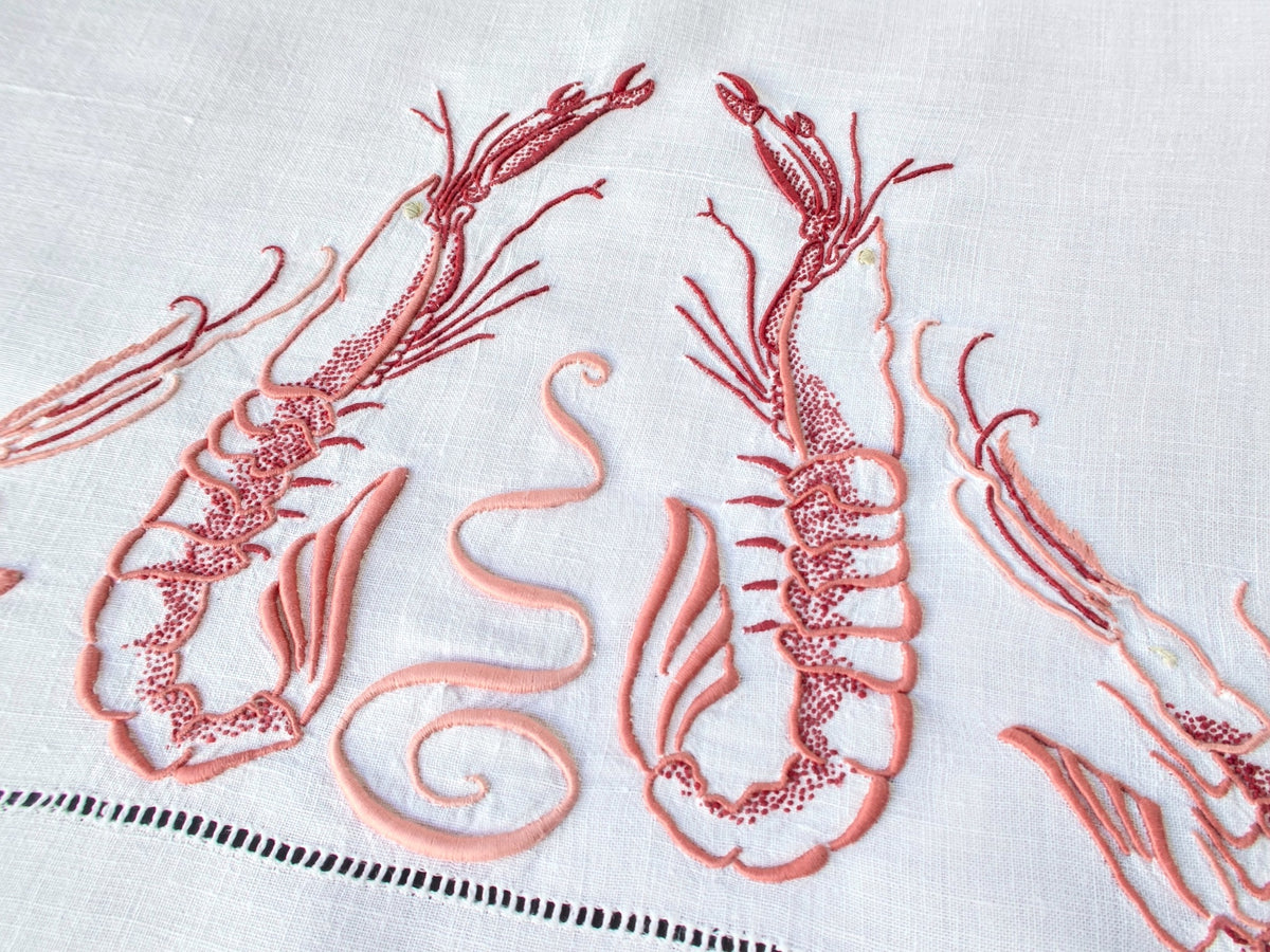 Detail of langoustine embroidery on antique French linen, showing three-dimensional stitchwork