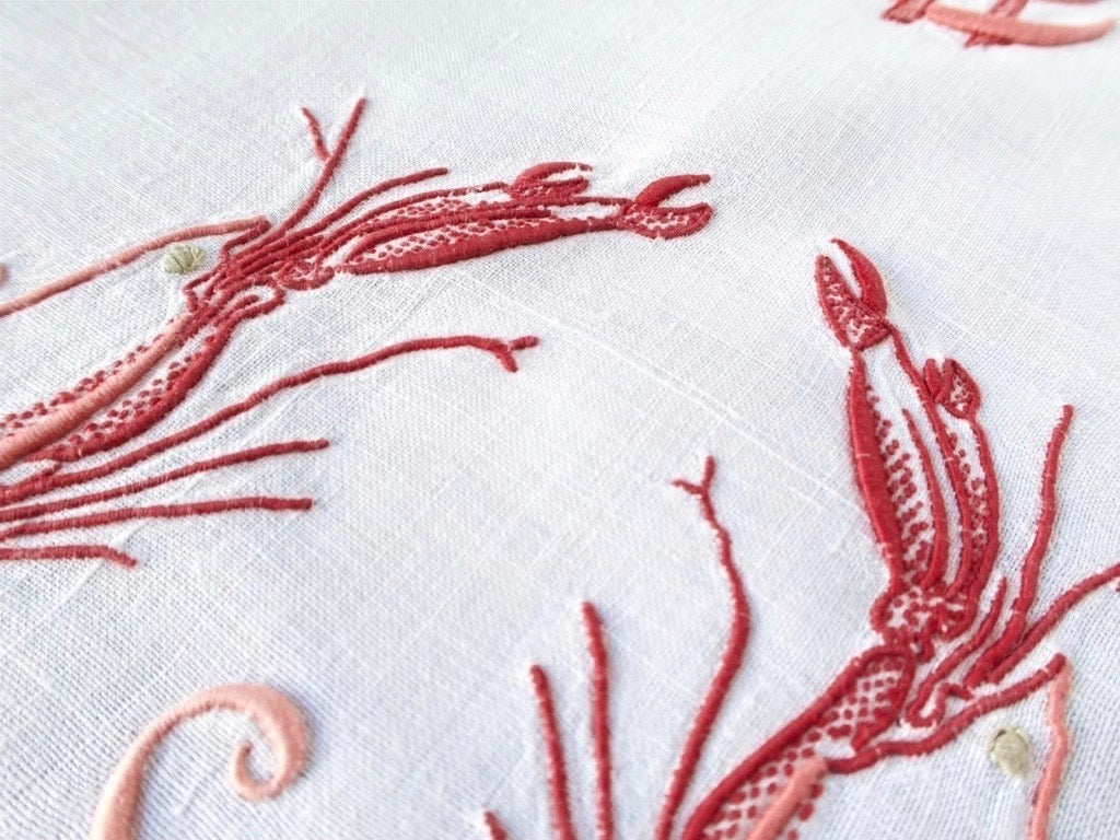 Detail of langoustine embroidery on antique French linen, showing three-dimensional stitchwork