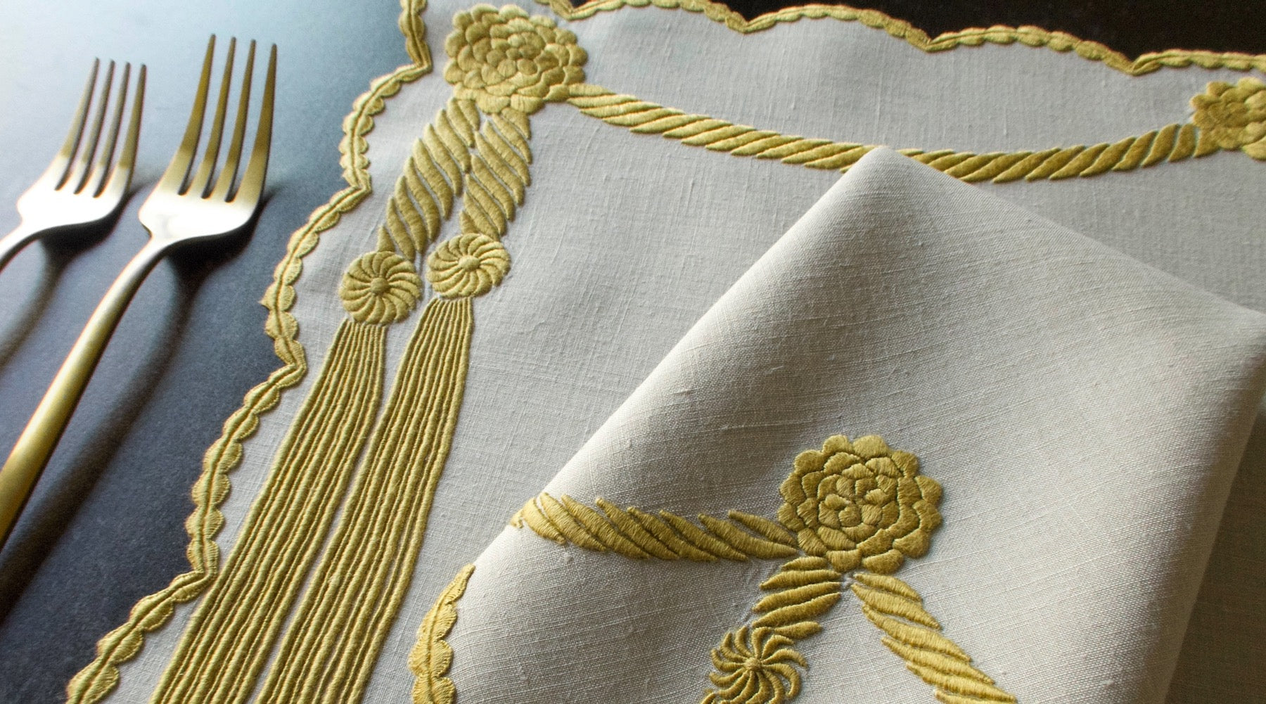 Vintage placemat and napkin in Marghab's "Cord & Tassel" pattern, featuring gold dimensional hand embroidery on fine linen, handmade in Madeira