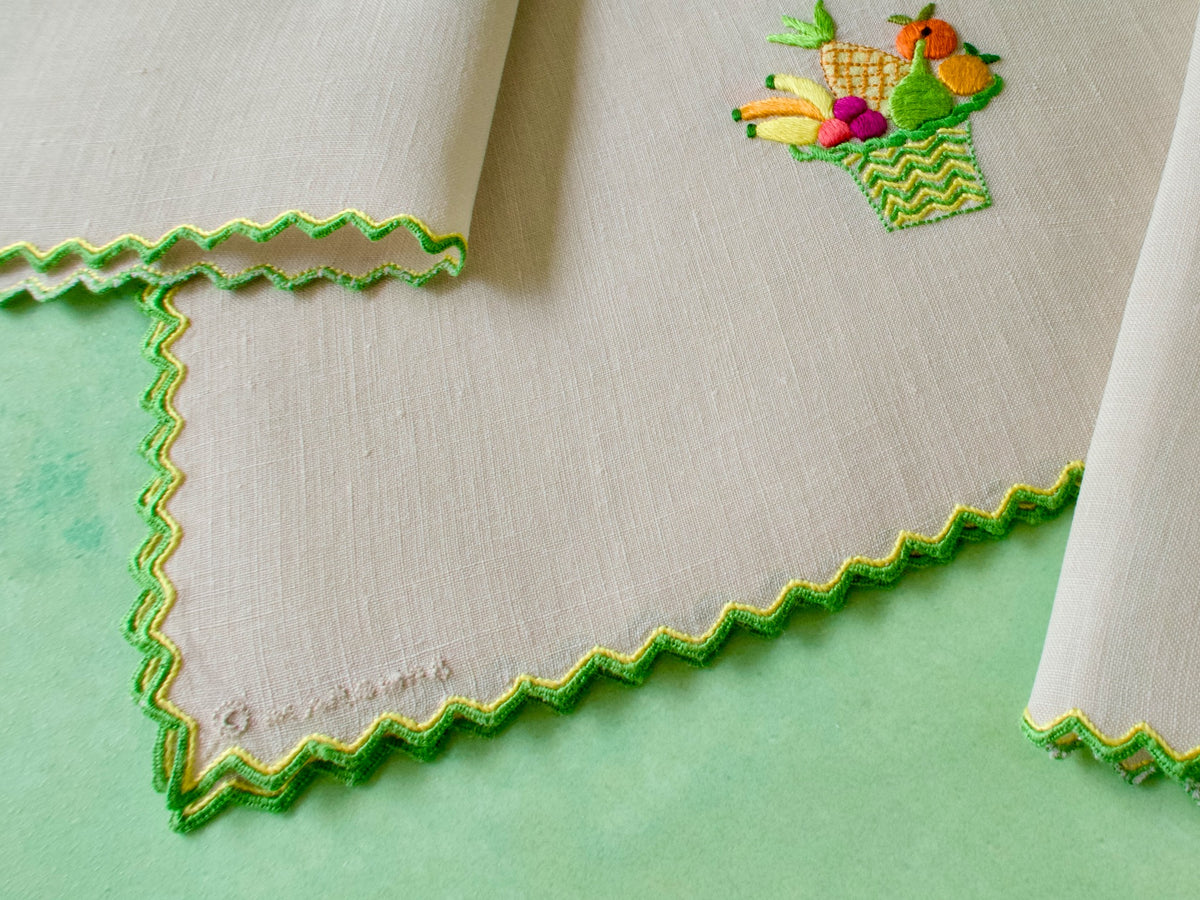 Close-up of Marghab copyright mark and signature embroidered directly on vintage linen Fruit Basket cocktail napkin