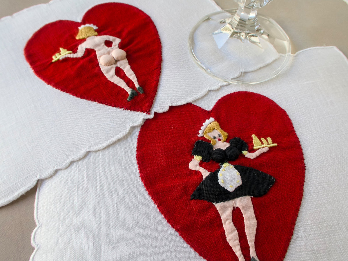 Vintage Madeira cocktail napkin with red heart appliqué and double-sided embroidered pin-up figure.