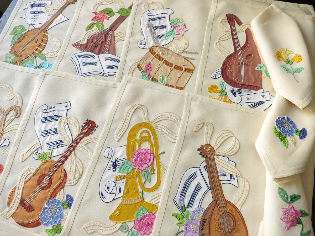 Vintage Italian embroidered placemats with musical instruments and flowers, full 24-piece set for 12.