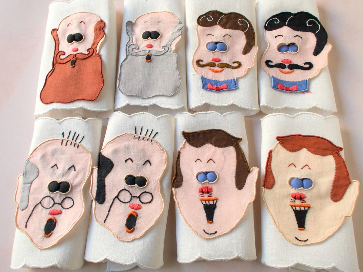 Vintage Madeira peek-a-boo cocktail napkins featuring embroidered men’s faces with blue padded ‘eyes’ that lift to reveal playful pin-up figures underneath. 