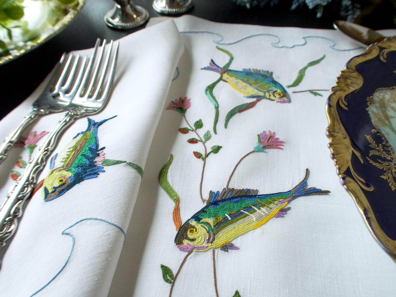 Vintage D. Porthault linen placemat hand embroidered with colorful fish in Beauvais stitch.