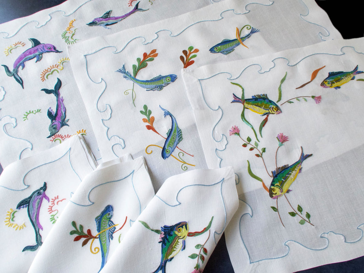 Vintage D. Porthault linen placemat hand embroidered with colorful fish in Beauvais stitch.