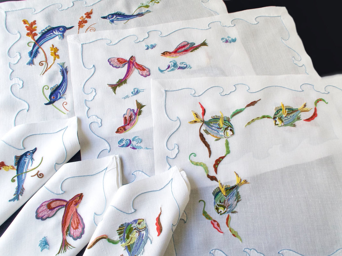 Vintage D. Porthault linen placemat hand embroidered with colorful fish in Beauvais stitch.