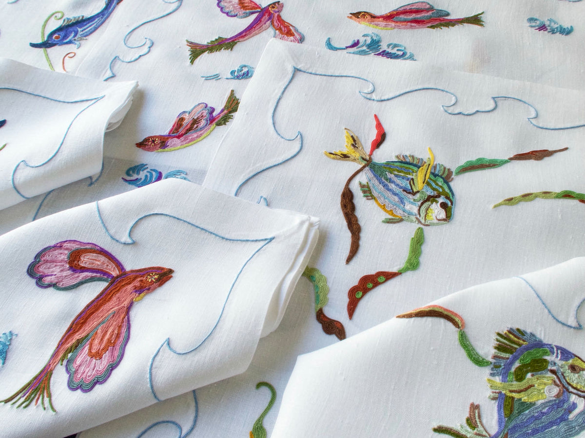 Vintage D. Porthault linen placemat hand embroidered with colorful fish in Beauvais stitch.