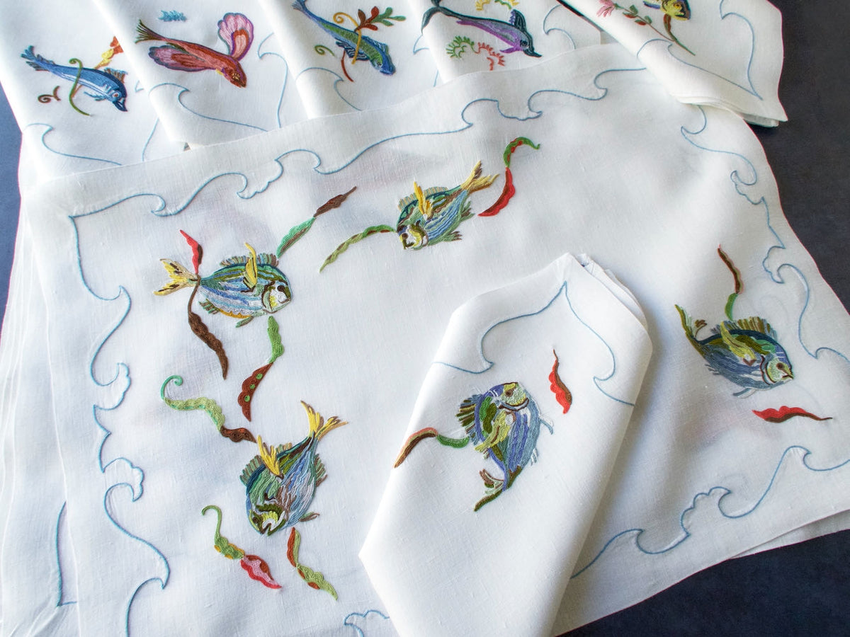 Vintage D. Porthault linen placemat hand embroidered with colorful fish in Beauvais stitch.