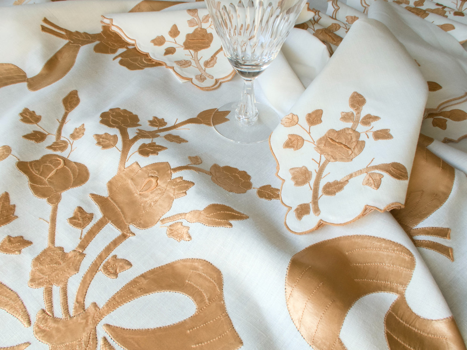 Detail of flowing satin ribbon embroidery on vintage Madeira tablecloth