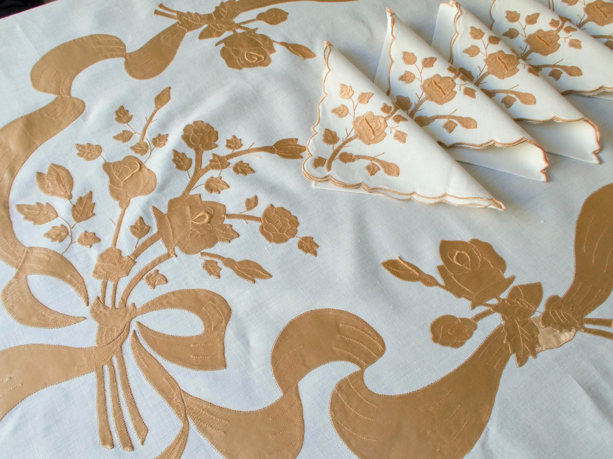 Stack of matching vintage Madeira linen napkins with satin appliqué
