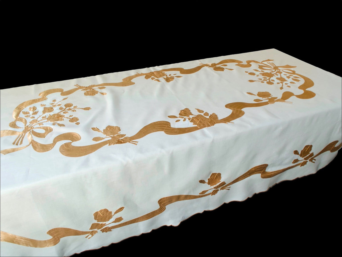 Vintage Madeira tablecloth draped on table showing satin appliqué pattern