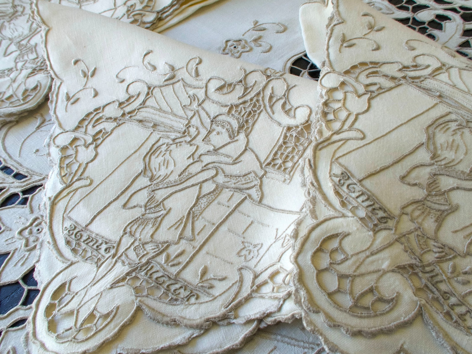 Vintage Madeira tablecloth with hand-embroidered Shakespeare scenes and Romeo & Juliet balcony motif.