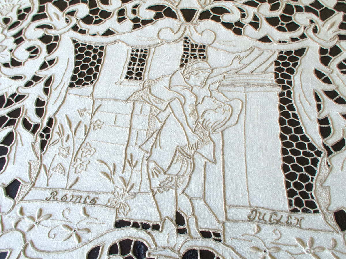 Vintage Madeira tablecloth with hand-embroidered Shakespeare scenes and Romeo &amp; Juliet balcony motif.