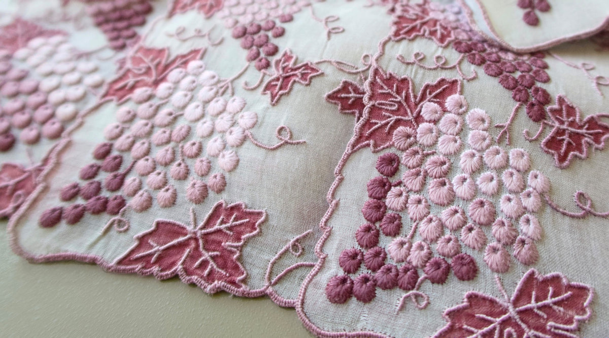 Marghab Vineyard vintage placemats with hand-embroidered grapes on sheer organdy.