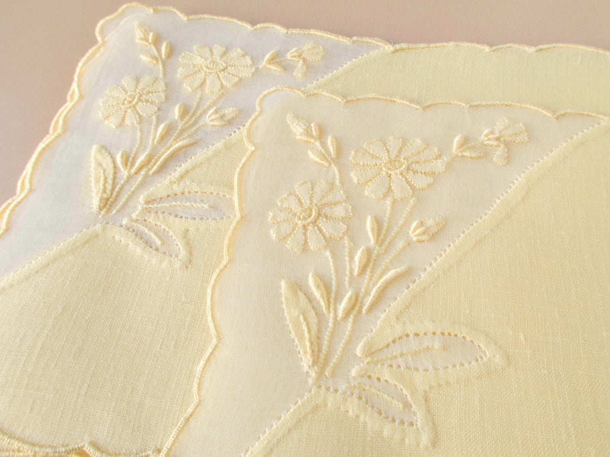 Close up of hand embroidered floral motif on vintage Madeira linen cocktail napkin, scalloped organdy window detail​​​​​​​​​​​​​​​​